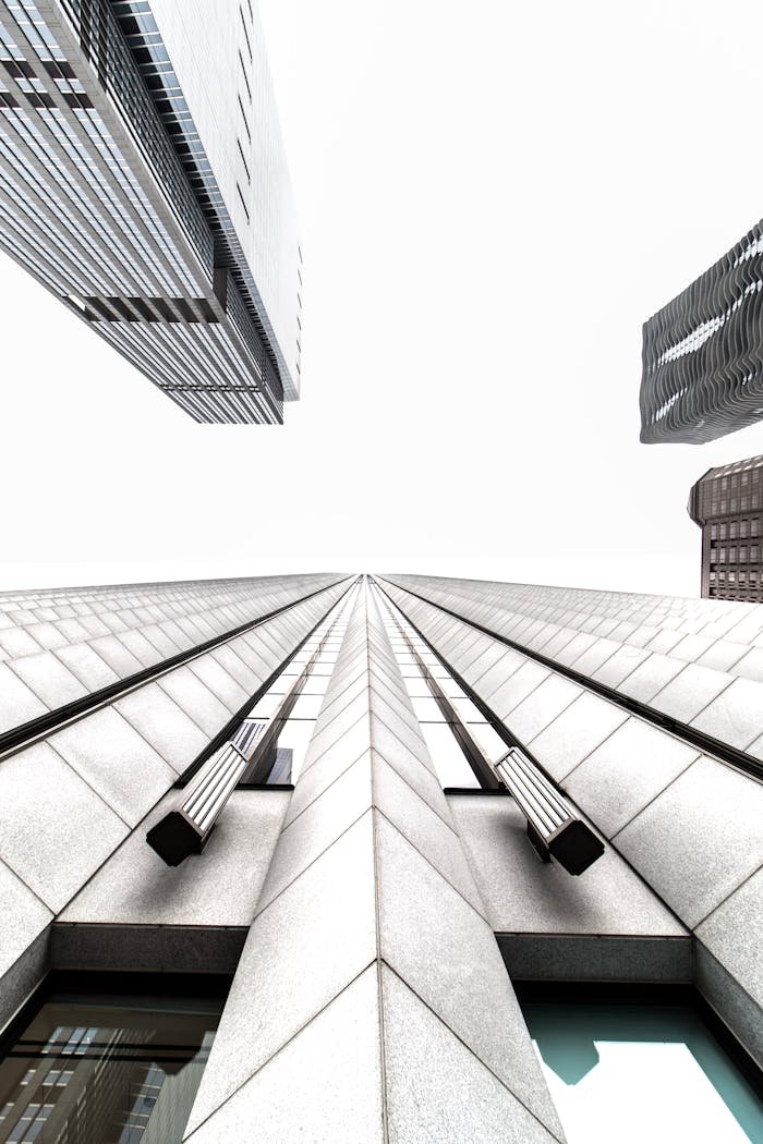 Low angle view of futuristic Chicago skyscrapers against a clear sky.